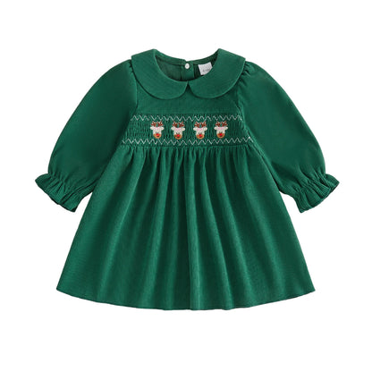Green corduroy baby and toddler girl Christmas dress with long sleeves and smocked reindeer embroidery.