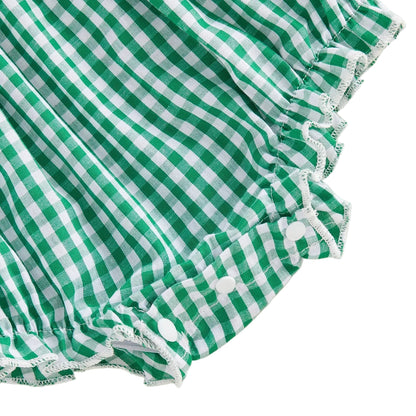 Close up of the elastic leg gatherings and bottom snap closures on the green gingham baby girl romper.