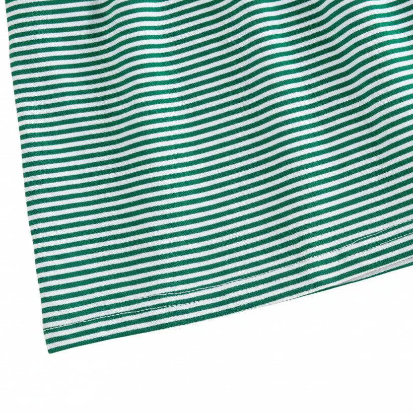 Close-up of the green and white horizontal striped cotton blend fabric and hemline of the toddler dress.