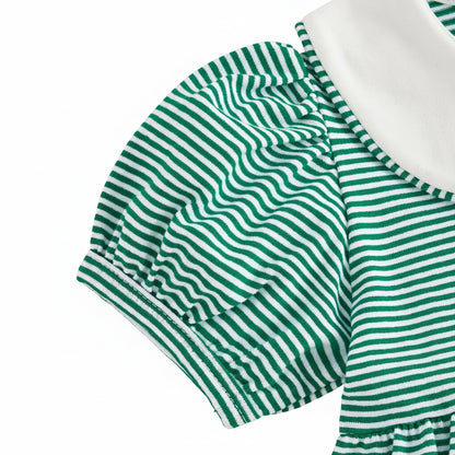 Close-up detail of the short puffed sleeve on the toddler girls green striped game day dress.