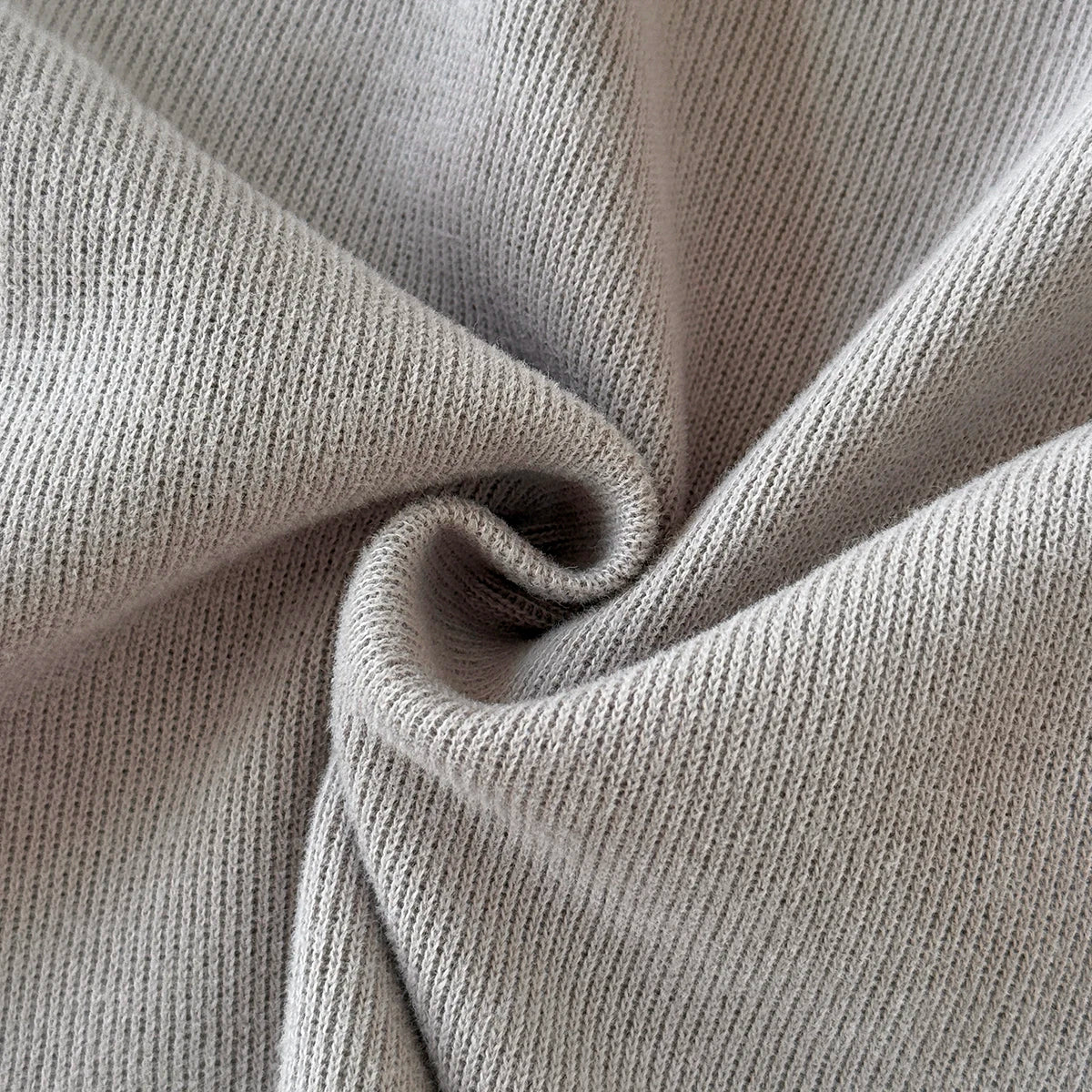 Close-up showing the soft, ribbed knit texture of the grey cotton blend fabric.