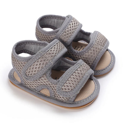 Grey first walker mesh sandals for babies, featuring a flexible developmental sole and mesh upper.