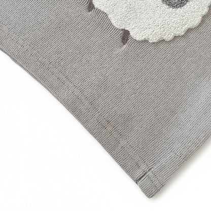 Close-up of the bottom hem stitching on the grey knit baby sheep sweater.
