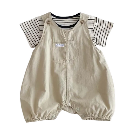 Flat lay of a baby boy 2-piece summer outfit featuring Hamptons Beige overalls and a black and white striped short-sleeve tee.
