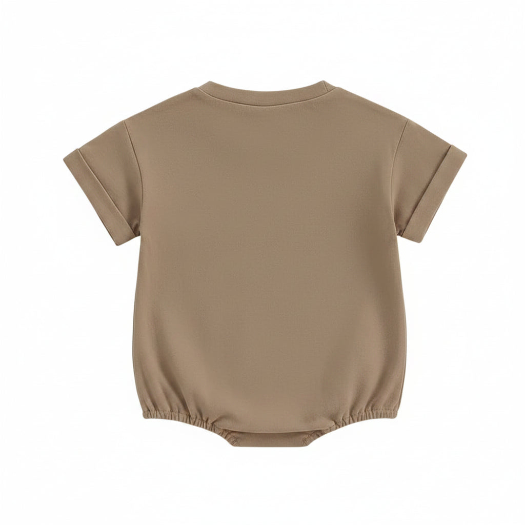 Flat lay showing the plain light brown back of the short-sleeve baby romper.