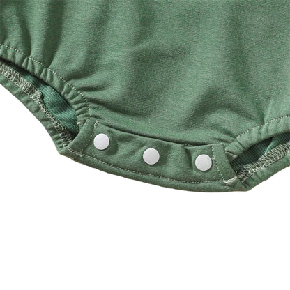 Close-up view of the three secure white plastic snap closures along the bottom hem of the baby bubble romper for quick diaper changes.