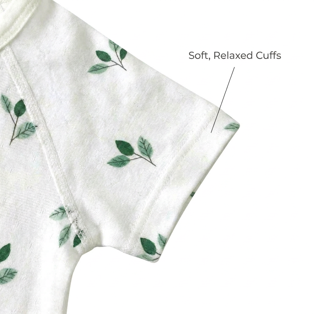 Zoomed-in view of the short sleeve on the green leaf print infant bodysuit highlighting the soft, relaxed cuffs for baby's arms.