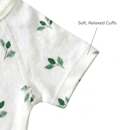 Zoomed-in view of the short sleeve on the green leaf print infant bodysuit highlighting the soft, relaxed cuffs for baby's arms.