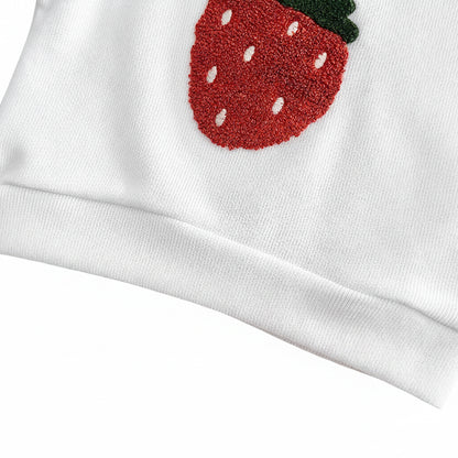 Detailed close-up of the premium combed cotton weave, elastic bottom hem, and stitched edge of the baby pullover with the bottom of the strawberry applique.