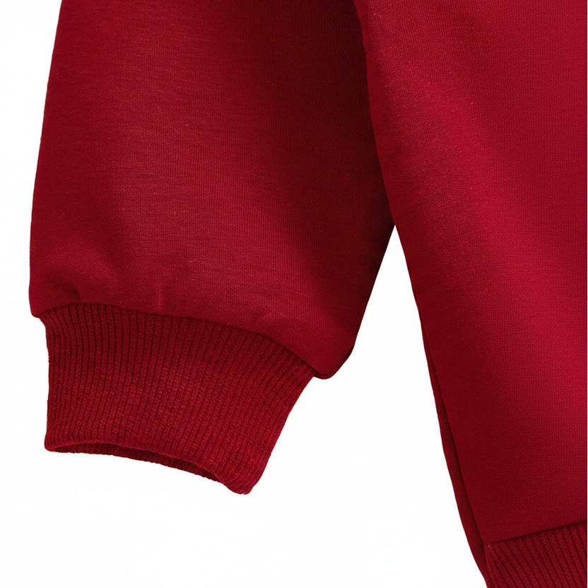 Close-up of the cozy banded long sleeve cuff on a crimson red premium infant bubble romper.