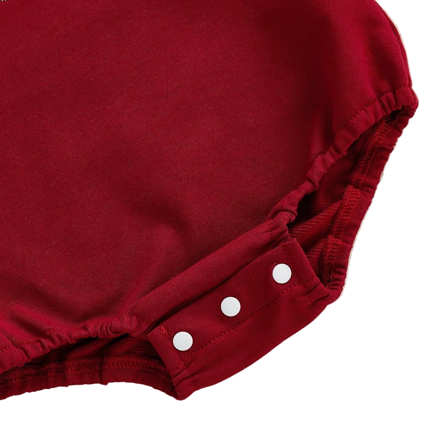 Close-up of robust bottom snap closures on a crimson red infant sweatshirt-weight bubble romper.