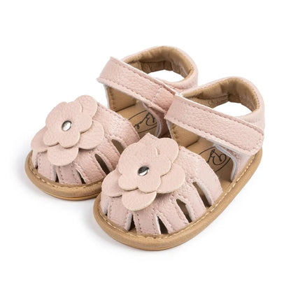 Light pink soft sole baby girl sandals featuring 3D floral applique and breathable cutout design.