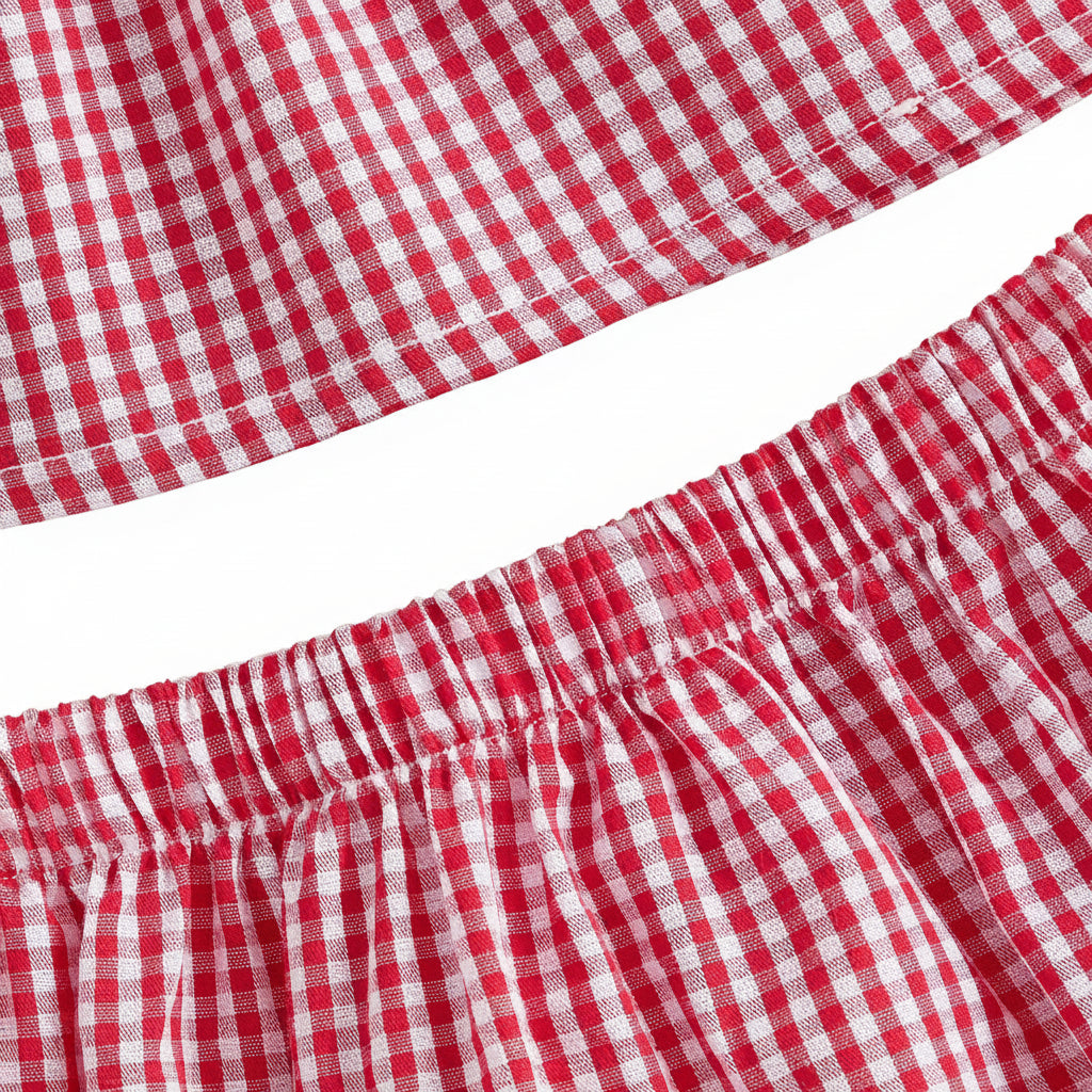 Macro view of the top hem of the matching red gingham diaper cover bloomers showing the high-stretch, comfortable elastic waistband.