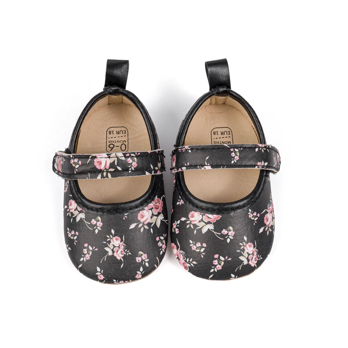 Pair of black infant girl floral dress shoes viewed from above.