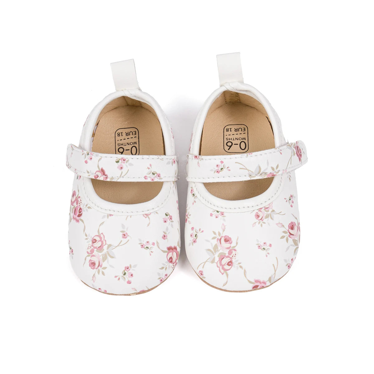 Top down view of white infant girl floral dress shoes showing the comfortable insoles.