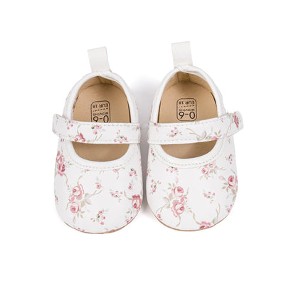 Top down view of white infant girl floral dress shoes showing the comfortable insoles.