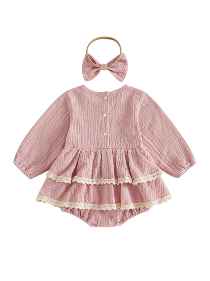 Back view of dusty pink long sleeve baby girl romper dress with double lace trim and matching headband on a white background.
