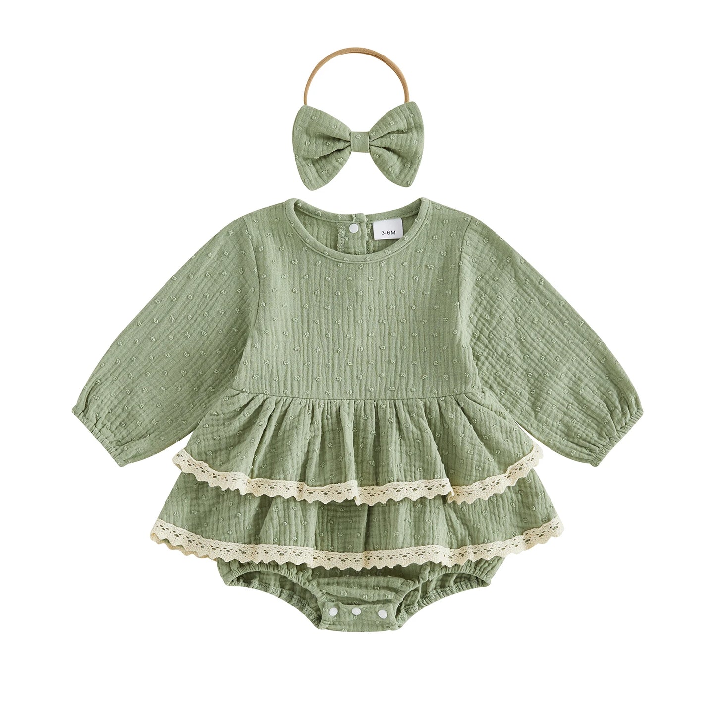 Sage green vintage-inspired infant girl puff sleeve romper dress with lace trim and matching bow headband on a white background.