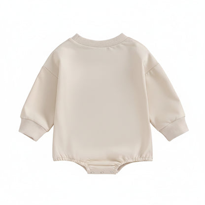 The plain back view of the neutral cream long-sleeve infant bubble romper layout.