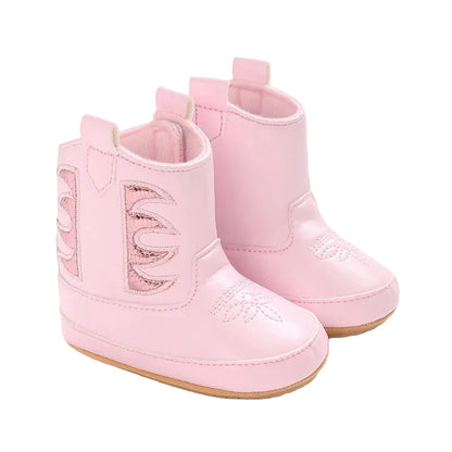 A pair of pink infant baby girl cowboy boots featuring metallic side panels and rubber soles on a white background.