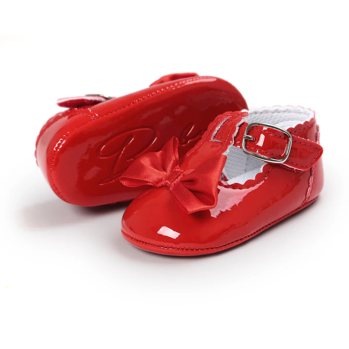 Side profile and back heel angle of infant red patent leather Mary Jane dress shoes highlighting the scalloped trim details.