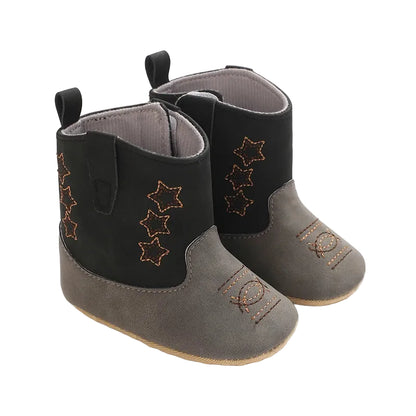 A pair of two-tone black and grey infant soft sole cowboy boots with star embroidery on a white background.