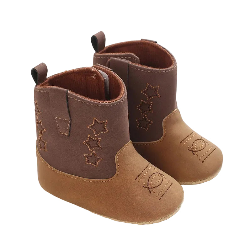 A pair of two-tone brown and tan infant soft sole cowboy boots with star embroidery on a white background.