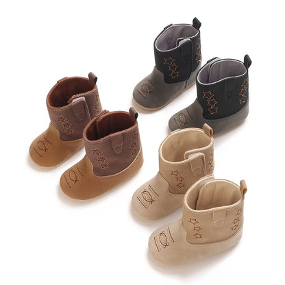 A group shot showing three color variations of infant two-tone soft sole cowboy boots: brown/tan, black/grey, and beige.