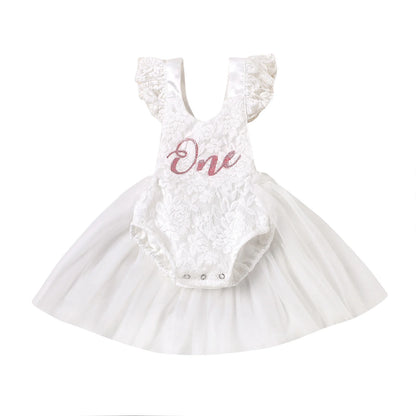 Infant white cake smash outfit featuring delicate lace ruffles, "One" lettering, and mesh tulle skirt for a princess birthday.