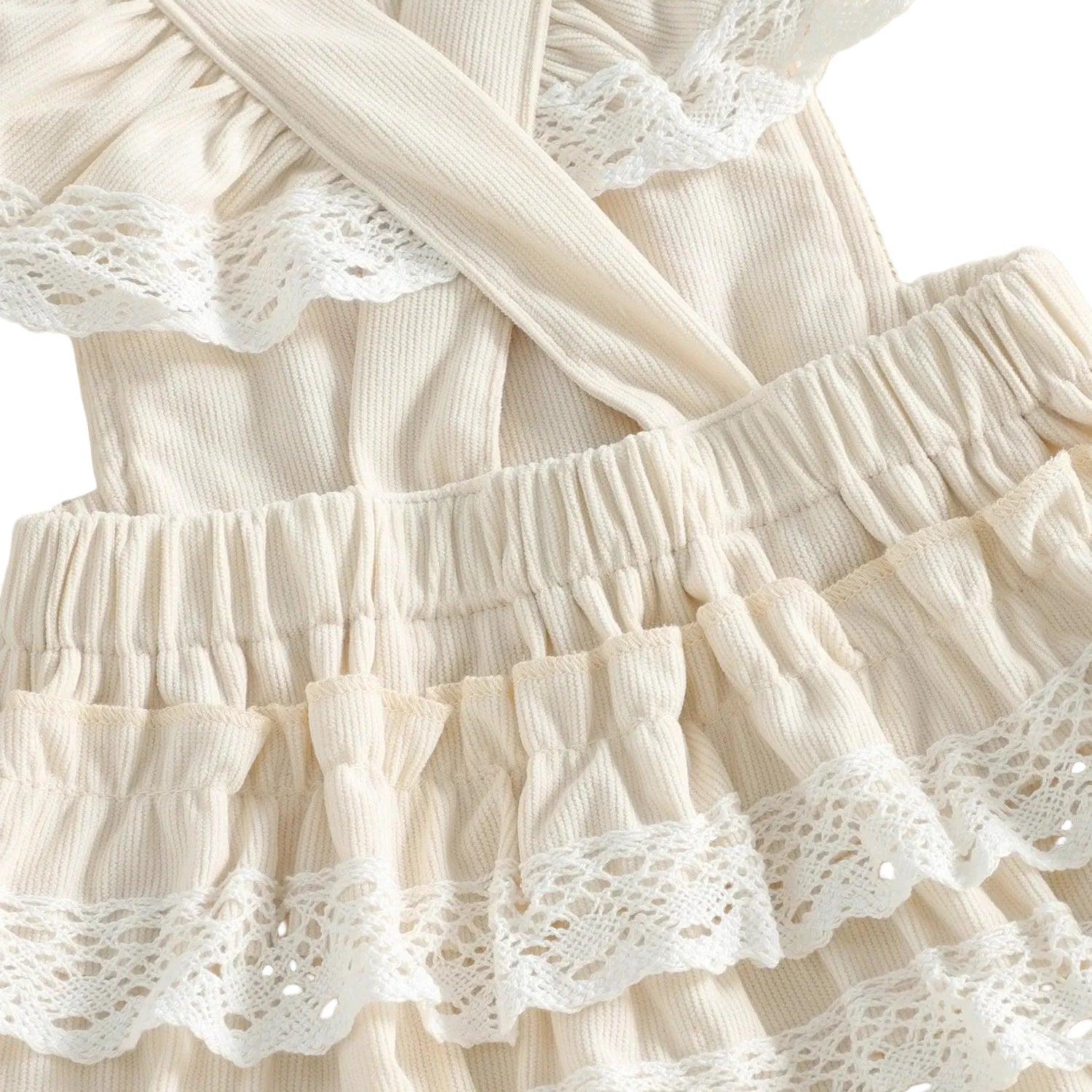 Close-up of the back of the ivory 6-month baby girl romper showing the cross-back straps and cute lace trim ruffle butt design.