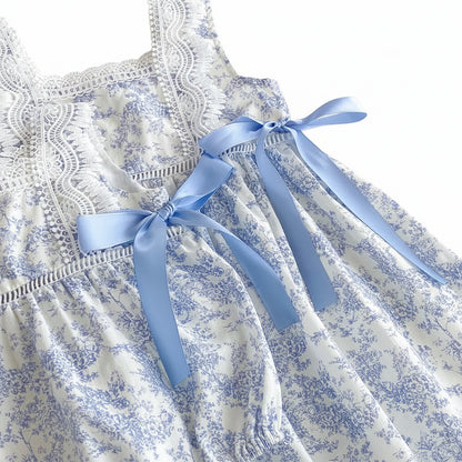 Close up of the intricate lace bodice and blue satin side-tie bow on the girls toile dress.