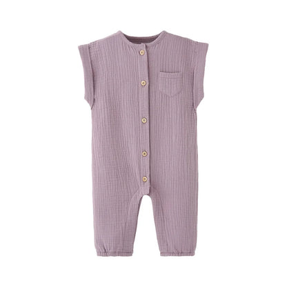 Front view of the vintage-inspired infant jumpsuit in a soft lavender purple, featuring a rolled cap sleeve and rustic buttons.