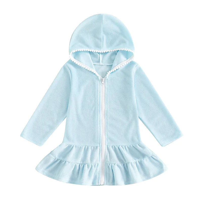 Light blue hooded zip-up beach robe for toddlers and little girls with long sleeves and white pom-pom detail.
