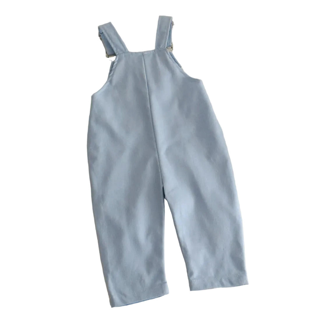 Back view of light blue toddler overalls showing the crossed adjustable suspender straps and smooth, solid-colored back fabric.