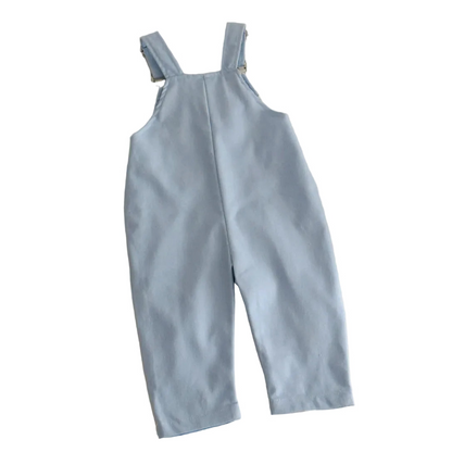 Back view of light blue toddler overalls showing the crossed adjustable suspender straps and smooth, solid-colored back fabric.