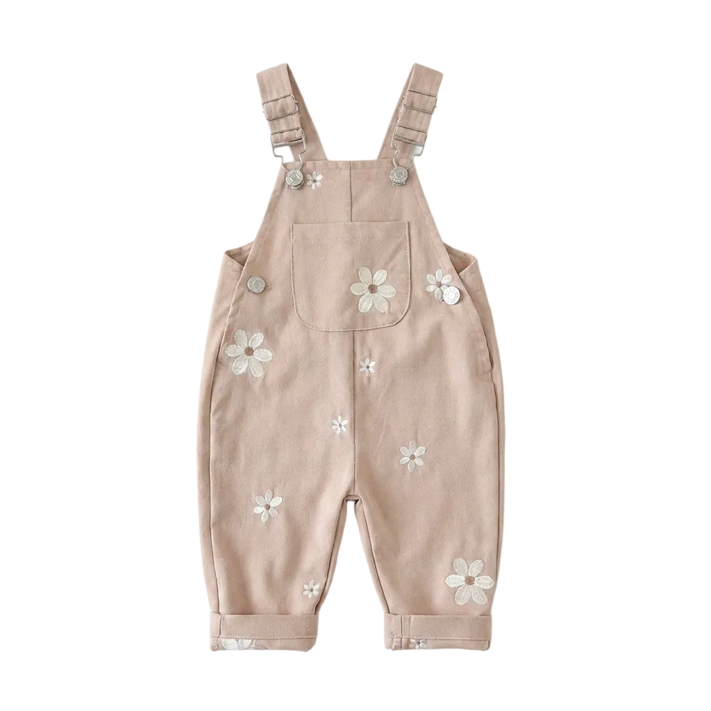 Light cocoa brown Kidsely toddler overalls featuring embroidered white daisies and a front chest pocket, displayed flat against a white background.
