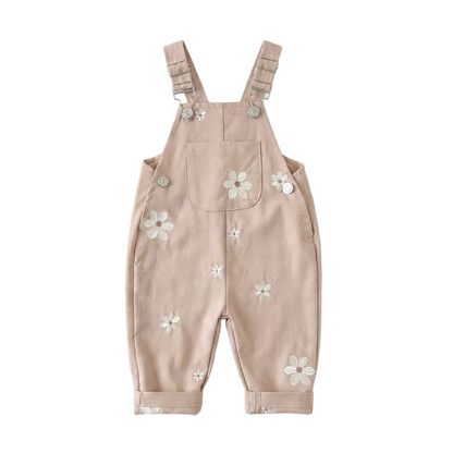 Light cocoa brown Kidsely toddler overalls featuring embroidered white daisies and a front chest pocket, displayed flat against a white background.