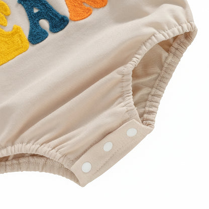 Close-up of the convenient bottom snap closures and the gathered elastic bubble leg opening on the Little Bean baby romper.