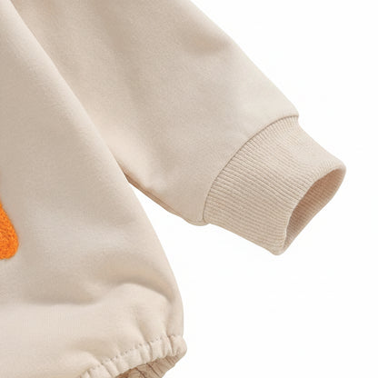 Close-up detail of the long sleeve and snug ribbed cuff on the neutral beige Little Bean baby romper.