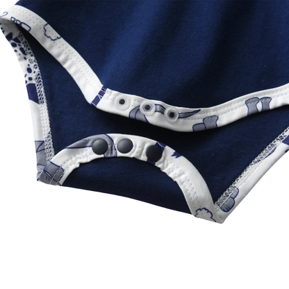 Close-up of the bottom snap closures on the navy blue little brother baby bodysuit, designed for quick and easy diaper changes.
