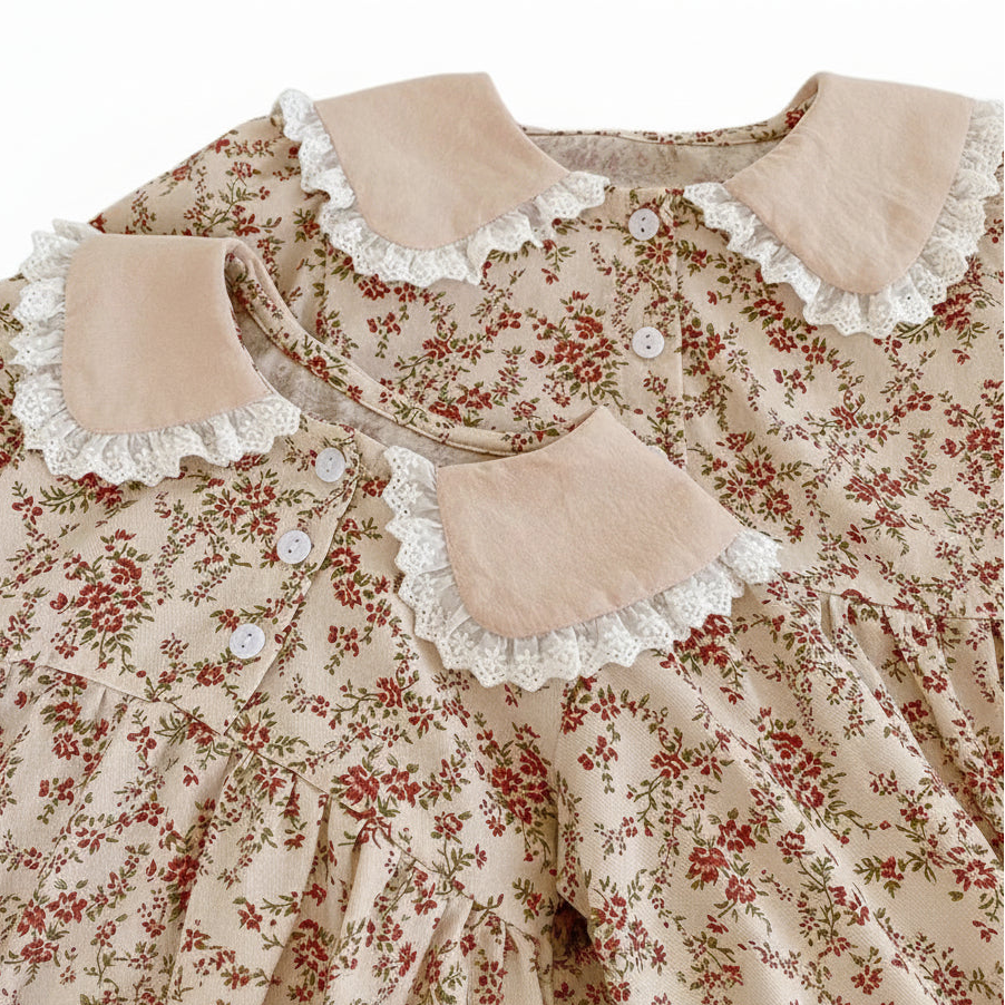 Close-up showing the matching contrast Peter Pan collars with delicate white lace trim for the baby romper and coordinating sibling dress.