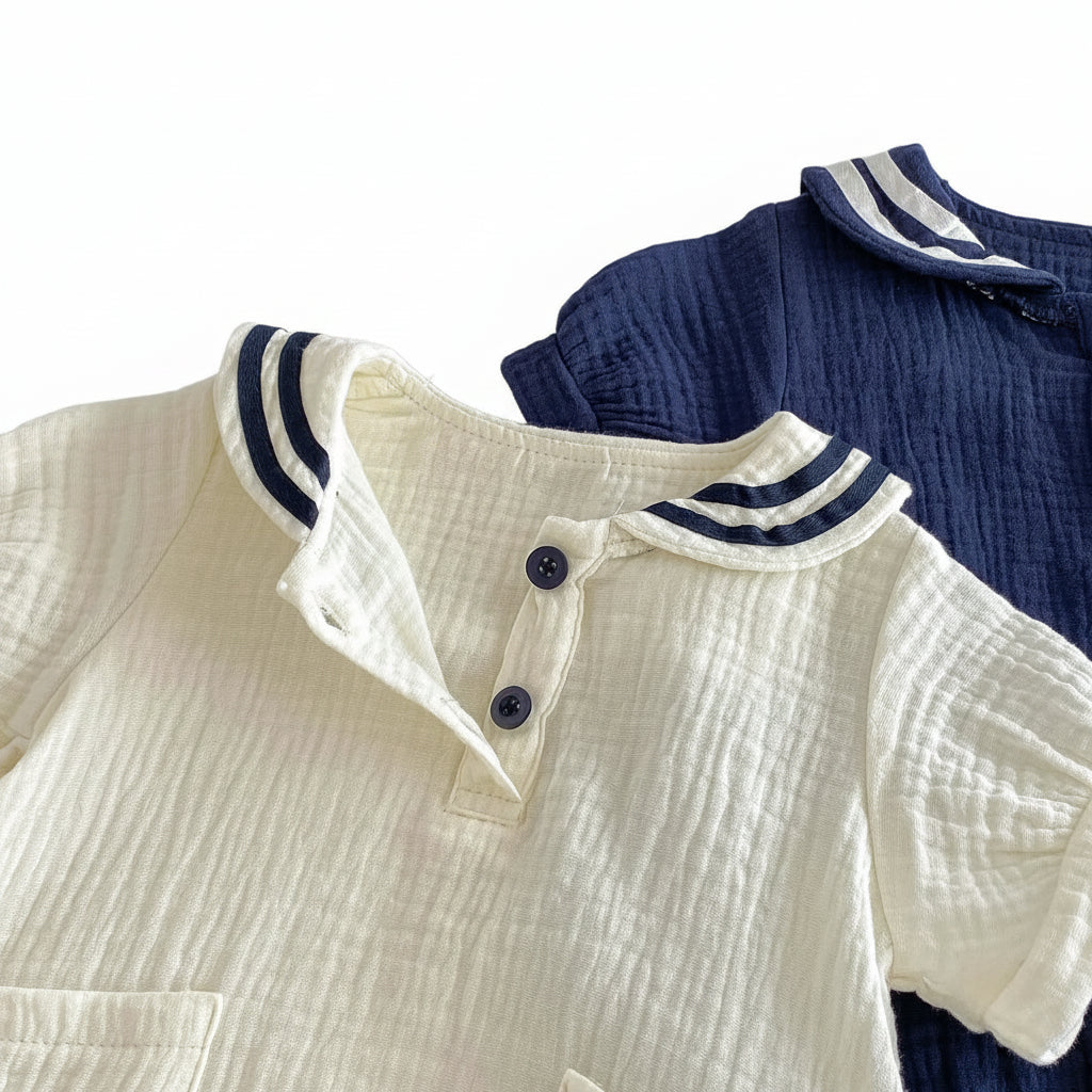 Close up shot of the vintage-inspired sailor collar with navy blue stripes and high-quality button front.
