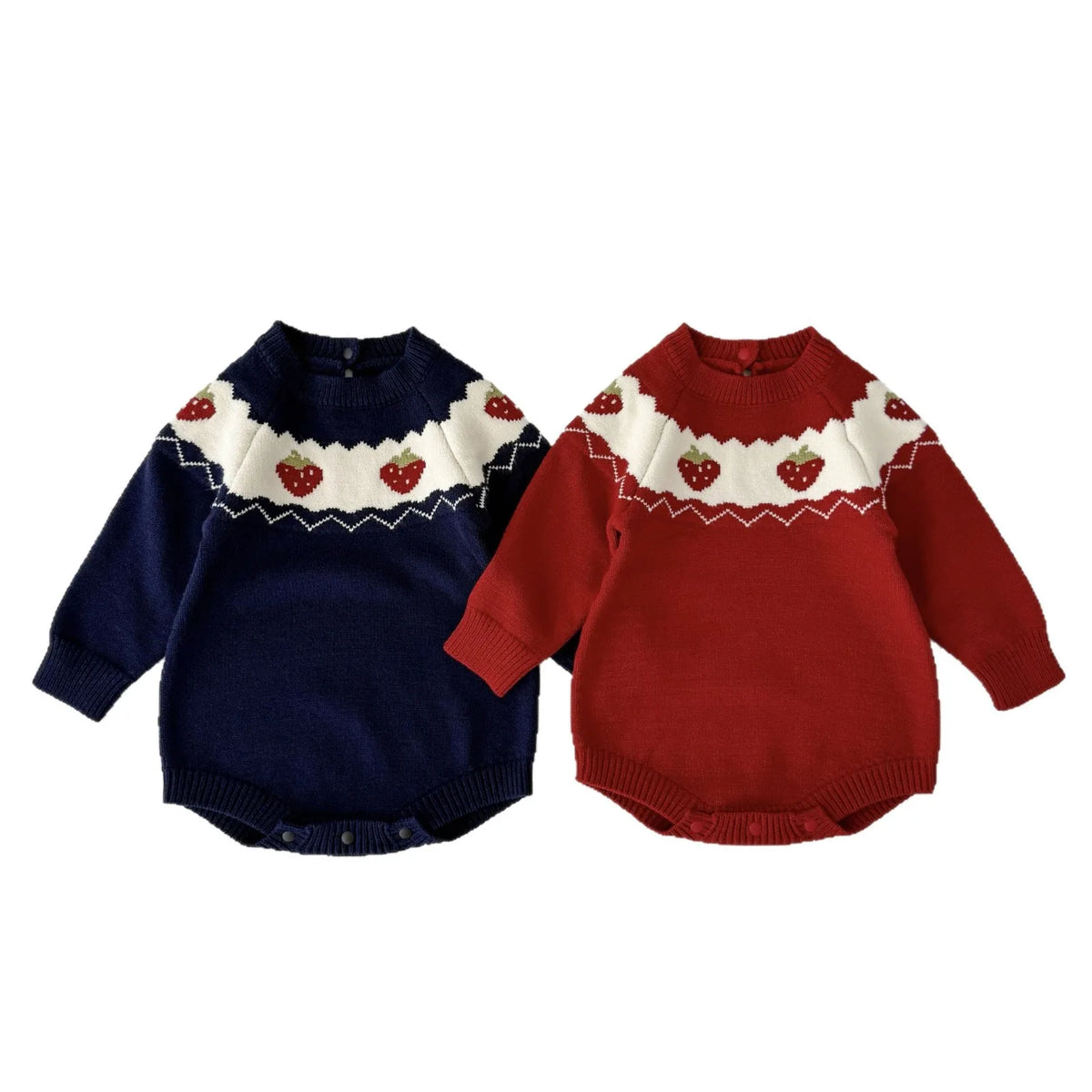 Navy blue and red baby girl long sleeve knit sweater rompers with strawberry patterns laid flat side-by-side.