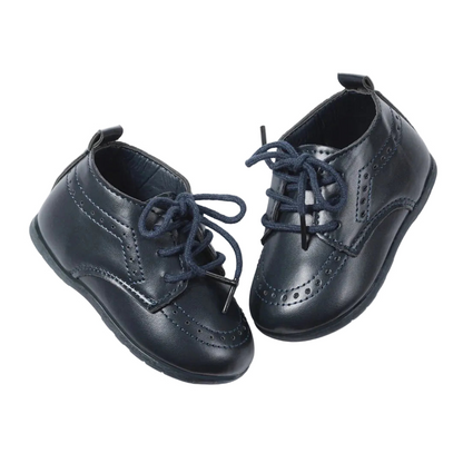Pair of Kidsely navy blue smooth faux leather infant brogue oxfords angled on a clean white background.