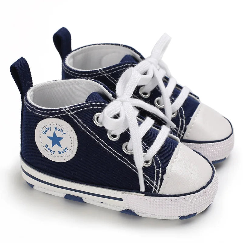 Navy blue unisex baby canvas sneakers with white laces and soft non-slip sole.