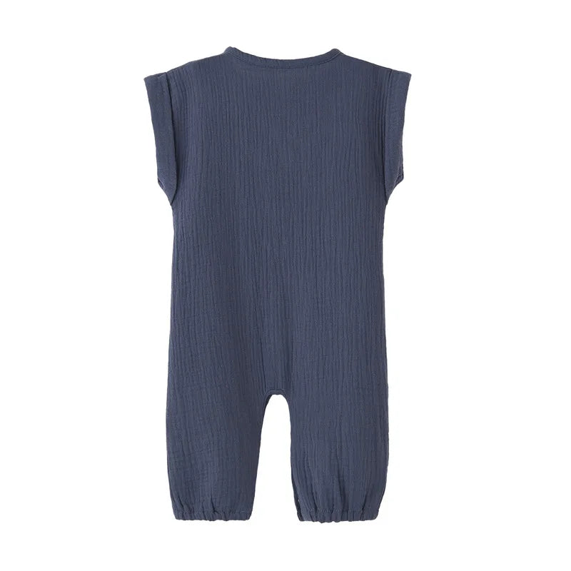 Back view of the navy blue neutral infant jumpsuit showing the rolled cap sleeve design.