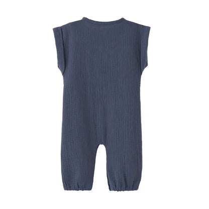 Back view of the navy blue neutral infant jumpsuit showing the rolled cap sleeve design.