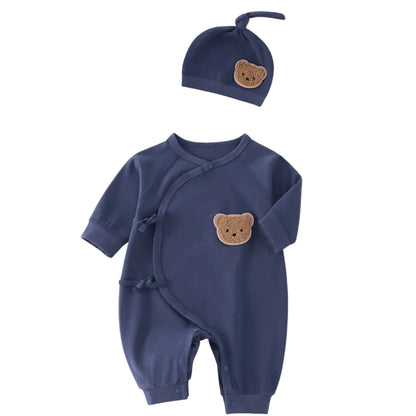 Navy blue infant wrap-style onesie with a matching hat, featuring teddy bear embroidery.