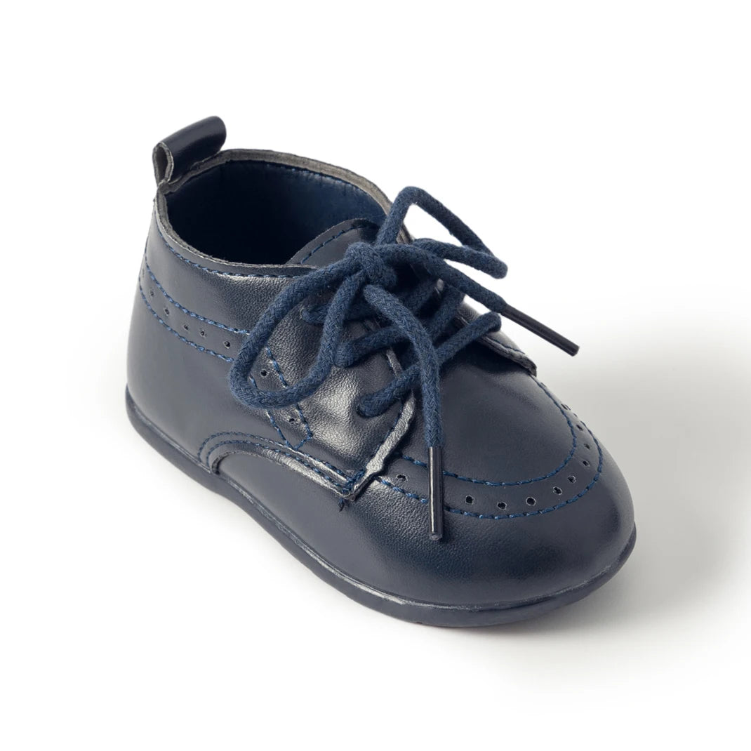 Single side-profile view of a Kidsely navy blue smooth faux leather toddler oxford shoe on a plain background.