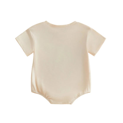 Back view of the plain cream short-sleeve baby golf romper showing the clean, simple design.